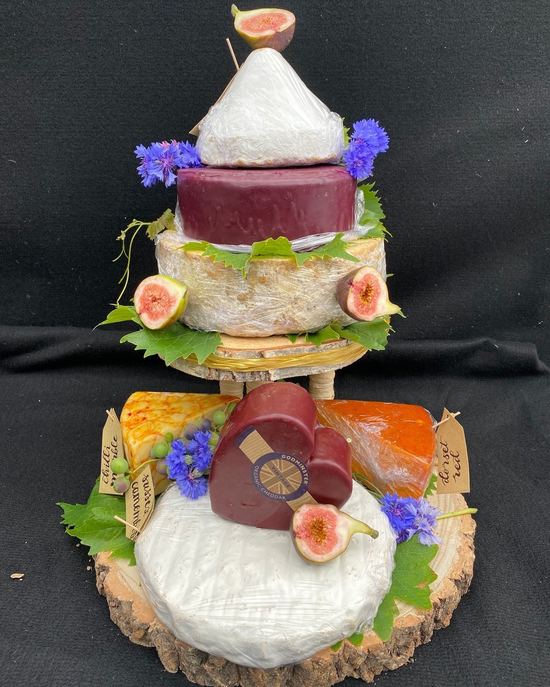 Today's cheese tower for a local wedding. It consists of 6 types of cheese, decorated with figs and our own grown cornflowers. #stilton with  Alsop & Walker 's Lord London and Sussex Brie;  Bruton Dairy 's Godminster Vintage Organic Cheddar, High Weald Dairy 's chilli marble; smoked Dorset red.  Do get in touch if you are interested in anything similar. Our best wishes to the bride & groom!

#britishcheese #cheeseweddingcake #farmshop